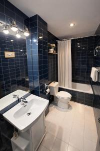 a bathroom with a sink and a toilet and a tub at Llívia Sky Valley in Llivia +9 photos