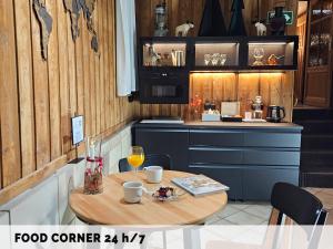 a kitchen with a small table with a food center at Hotel Protea Bolesławiec in Bolesławiec