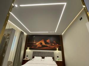 a bedroom with a bed with a painting on the ceiling at Golden mask pyramids inn in Cairo