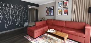 a living room with a red couch and a table at Hollywood Casino at Greektown in Detroit