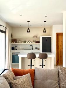 a living room with a couch and a kitchen at Dar Youba, Luxe Villa Taghazout in Taghazout