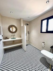 a bathroom with a sink and a mirror at Dar Youba, Luxe Villa Taghazout in Taghazout +24 photos