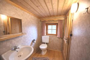 a bathroom with a sink and a toilet and a window at Almhütte Santnerhof - Hochgebirgshütte 1750m - This is a remote high mountain hut in Virgen