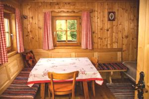 a dining room with a table and a window at Almhütte Santnerhof - Hochgebirgshütte 1750m - This is a remote high mountain hut in Virgen