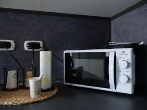 a microwave sitting on a counter next to a wall at Casa Villaggio Laguna in Mestre