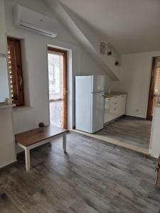 a kitchen with a refrigerator and a table in it at Ampia terrazza privata a due passi da Pizzo e Tropea in Vibo Valentia Marina