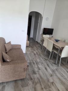 a living room with a couch and a table at Ampia terrazza privata a due passi da Pizzo e Tropea in Vibo Valentia Marina