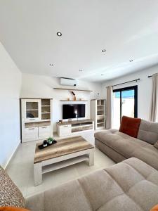 a living room with a couch and a coffee table at Dar Youba, Luxe Villa Taghazout in Taghazout