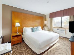 a hotel room with a large bed and a television at Oscoda Lakeside Hotel in Oscoda +31 photos