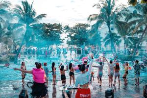 a group of people in the water at a swimming pool at Leo'J Hotel & Apartment in Phú Quốc