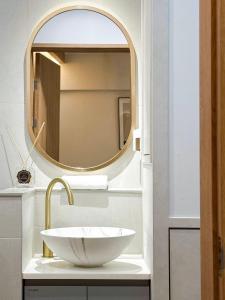 a bathroom with a sink and a mirror at Euljiro Central 3BR Stay in Seoul
