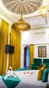 a living room with a bed and a chandelier at Riad Lala Zehra in Fez