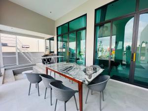 a dining room with a table and chairs at Baby Blue pool villa in Ban Bo Prakhon