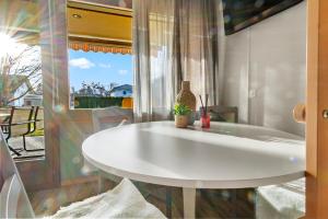 a white table in a room with a window at Cari'Stay in Portalban- Dessous +238 photos