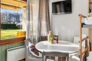 a small dining room with a table and a window at Cari'Stay in Portalban- Dessous