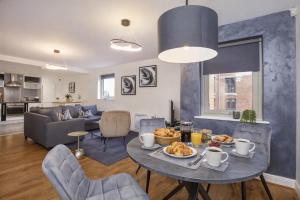 a living room with a table with food on it at Dixon's Yard, City Centre - Free Parking in York