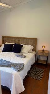 a bedroom with a bed and a table with a lamp at El Joaquin in Nono