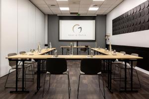 a conference room with tables and chairs and a screen at Best Western Hotel le Galice Aix-en-Provence in Aix-en-Provence +112 photos