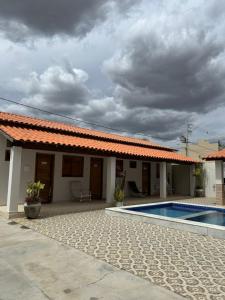 a house with a swimming pool in front of it at Recanto da Lapinha in Piranhas +15 photos