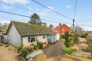 a small house with a gravel driveway in front of it at 3 Bed in Stratford St. Andrew oc-swint in Farnham