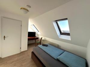 a bedroom with a bed and a window and a desk at Gästehaus am Harz in Goslar