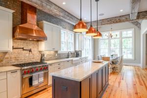 a large kitchen with white cabinets and a counter top at 233 Glen Abbey in Kiawah Island