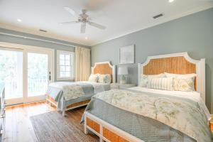a bedroom with two beds and a ceiling fan at 233 Glen Abbey in Kiawah Island +59 photos