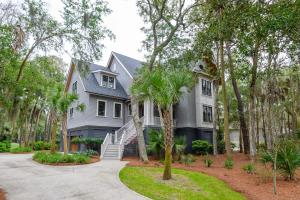 a gray house with palm trees in front of it at 233 Glen Abbey in Kiawah Island
