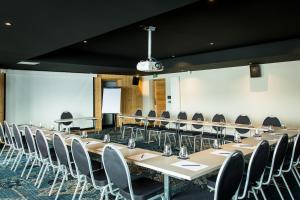 a conference room with long tables and chairs at Hôtel Daria-I Nor by Les Etincelles in L'Alpe-d'Huez +79 photos