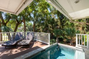 a porch with a chair and a swimming pool at 13 Angler Hall in Kiawah Island