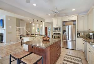 a kitchen with white cabinets and a kitchen island with a ceiling at 13 Angler Hall in Kiawah Island
