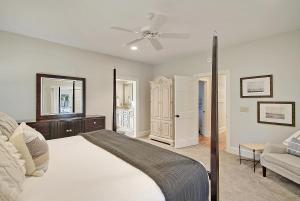 a bedroom with a bed and a ceiling fan at 13 Angler Hall in Kiawah Island +55 photos
