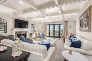 a living room with white furniture and a fireplace at 15 Ocean Course in Kiawah Island