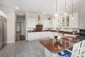 a kitchen with white cabinets and a large island at 15 Ocean Course in Kiawah Island