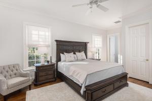 a bedroom with a bed and a chair and a window at 15 Ocean Course in Kiawah Island +75 photos