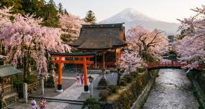 a pagoda in a garden with a mountain in the background at KINO SPACE Kyoto in Kyoto