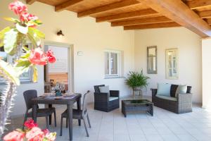 a patio with a table and chairs and a table at Sole d'Estate Agriresidence in Costa Rei