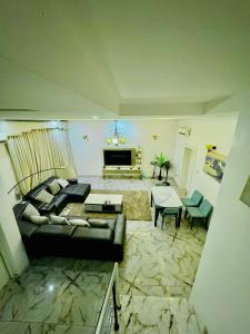 a living room with a couch and a fireplace at Polo Apartments Lekki in Lekki