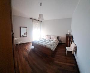 a bedroom with a bed and a wooden floor at Bella Vista in Canelli