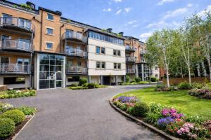 an apartment building with a driveway and flowers at Dixon's Yard, City Centre - Free Parking in York