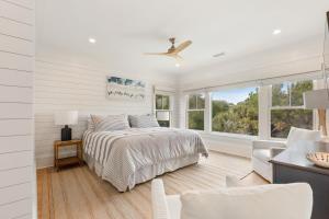 a white bedroom with a bed and a window at 3 Surfsong in Kiawah Island +49 photos