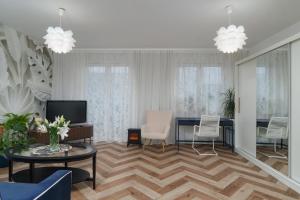 a living room with a table and chairs at Cozy Attic in Marki