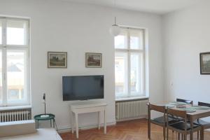 a living room with a flat screen tv on a wall at Apartment Hans - Wohnen im Herzen des Drautales in Feistritz an der Drau