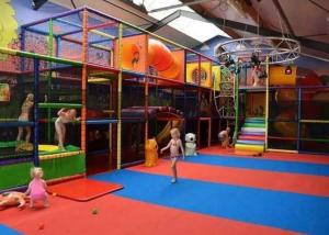 a group of children playing in an indoor playground at Chalet Pallegarste 153 in Mariënberg