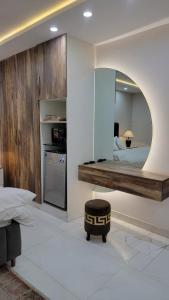 a bedroom with a large mirror and a bed at Regency Crown Hotel in Faisalabad