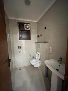 a bathroom with a toilet and a sink at 3BHK Independent Floor in New Delhi