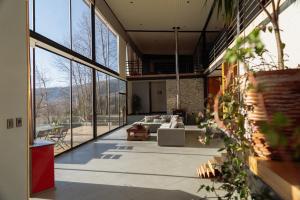 a living room with large windows and a couch at The Black House in Recinto
