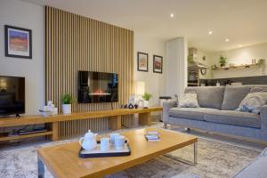 a living room with a couch and a table at Riverside Park 1 in Keswick