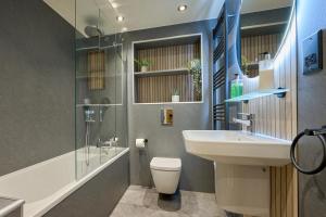 a bathroom with a sink and a toilet and a shower at Riverside Park 1 in Keswick +25 photos