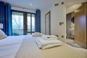 a room with a bed with towels on it at Riverside Park 1 in Keswick